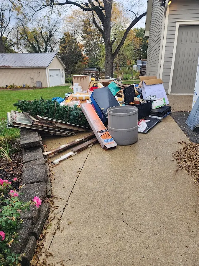 Dumpster being loaded with debris for 12 Yard Dumpster Rental in Northville